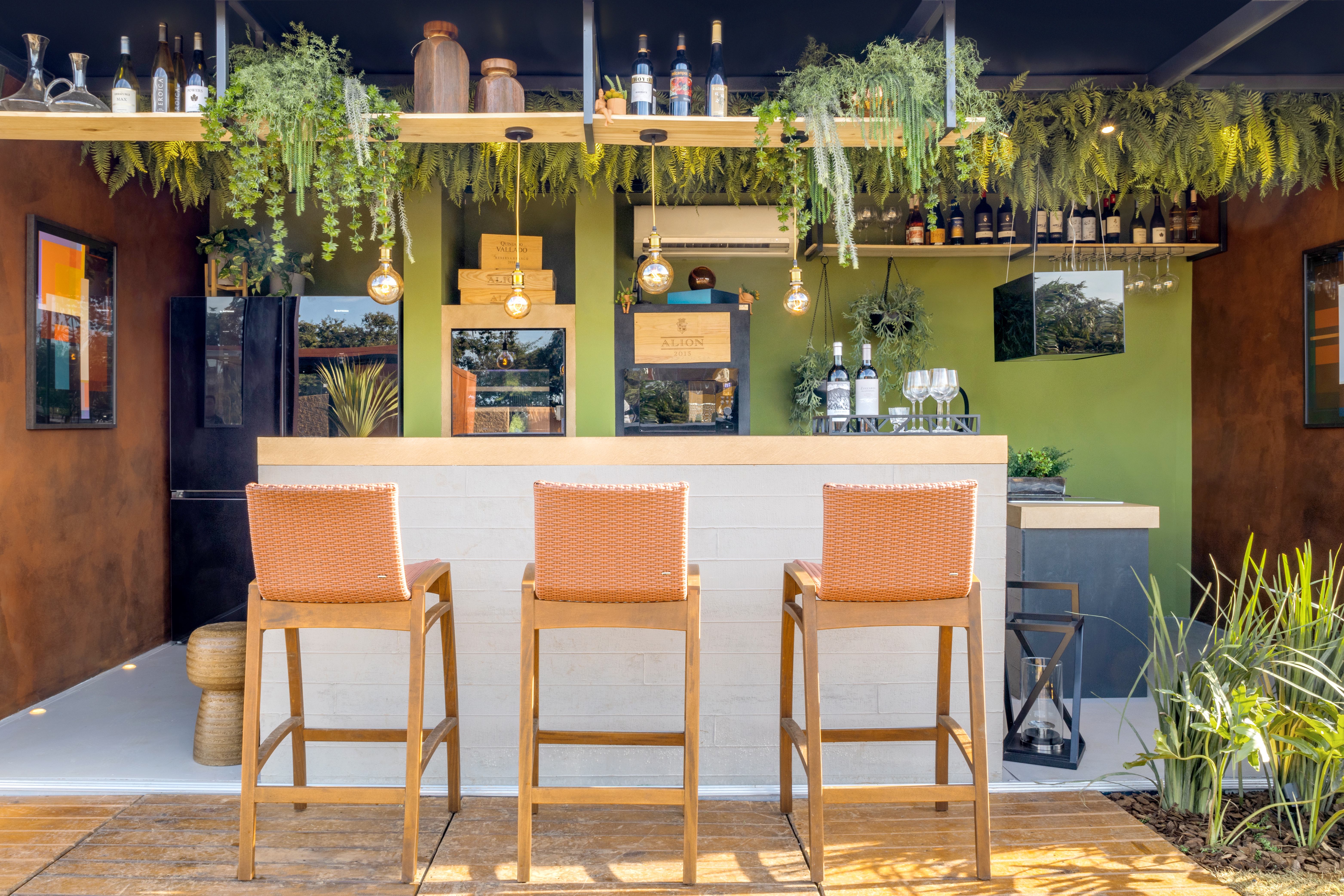  Bruno Cattini e Gustavo Carneiro- O Wine Bar. Assinado pelos arquitetos Bruno Cattini e Gustavo Carneiro possui um layout que prioriza a integração. Composto por uma área interna e outra externa que acolhe mesas e petits lounges, o local tem como destaque o uso de revestimentos e texturas, cores e muitos elementos naturais para criar conexão com o público.  Com arquitetura intimista e cosmopolita, o ambiente se torna convidativo a apreciar um bom vinho e momentos descontraídos. O paisagismo foi assinado por Iemíria Rezende, que trouxe as palmeiras do cerrado, típicas das nossas praias e cachoeiras, além de belíssimos vasos Vietnamitas, incorporando a elegância do simples e natural com a sensibilidade do requinte.